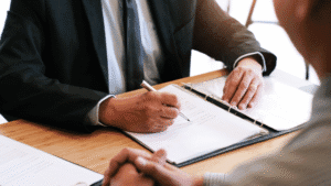 a recruiter sitting at a table with a candidate doing an interview