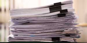 a stack of resumes on top of a desk