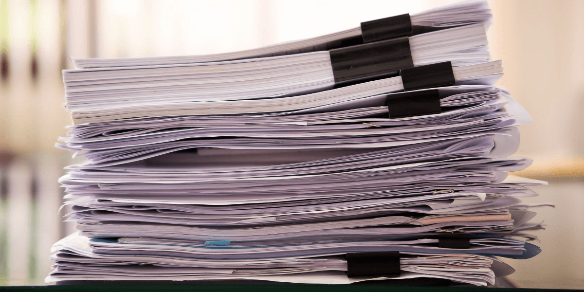 a stack of resumes on top of a desk